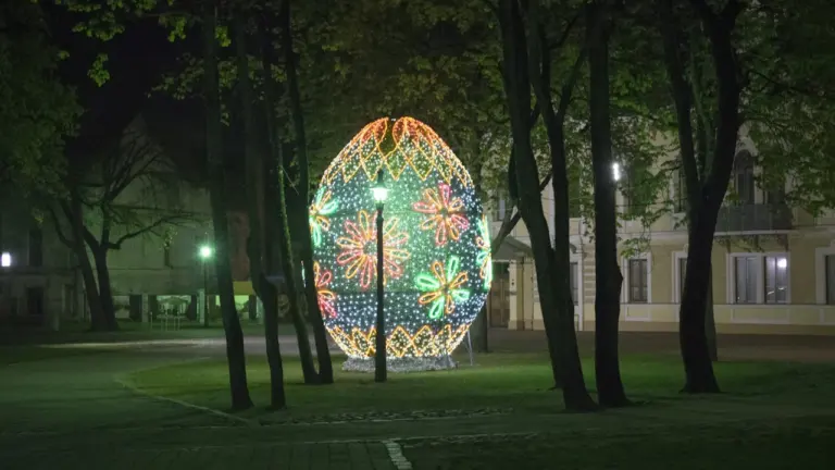Didelis šviečiantis kiaušinis Kaišiadorių parke vakariniu metu, simbolizuojantis miesto šventinę nuotaiką.