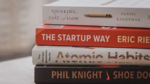 Knygų apie verslo augimą ir startuolius krūva ant stalo verslo straipsniui.