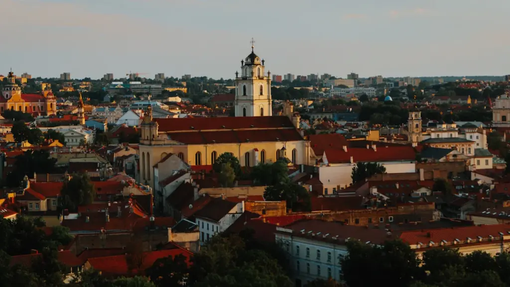 Panoraminis Vilniaus senamiesčio vaizdas su bažnyčių bokštais saulėlydžio šviesoje rudens metu.